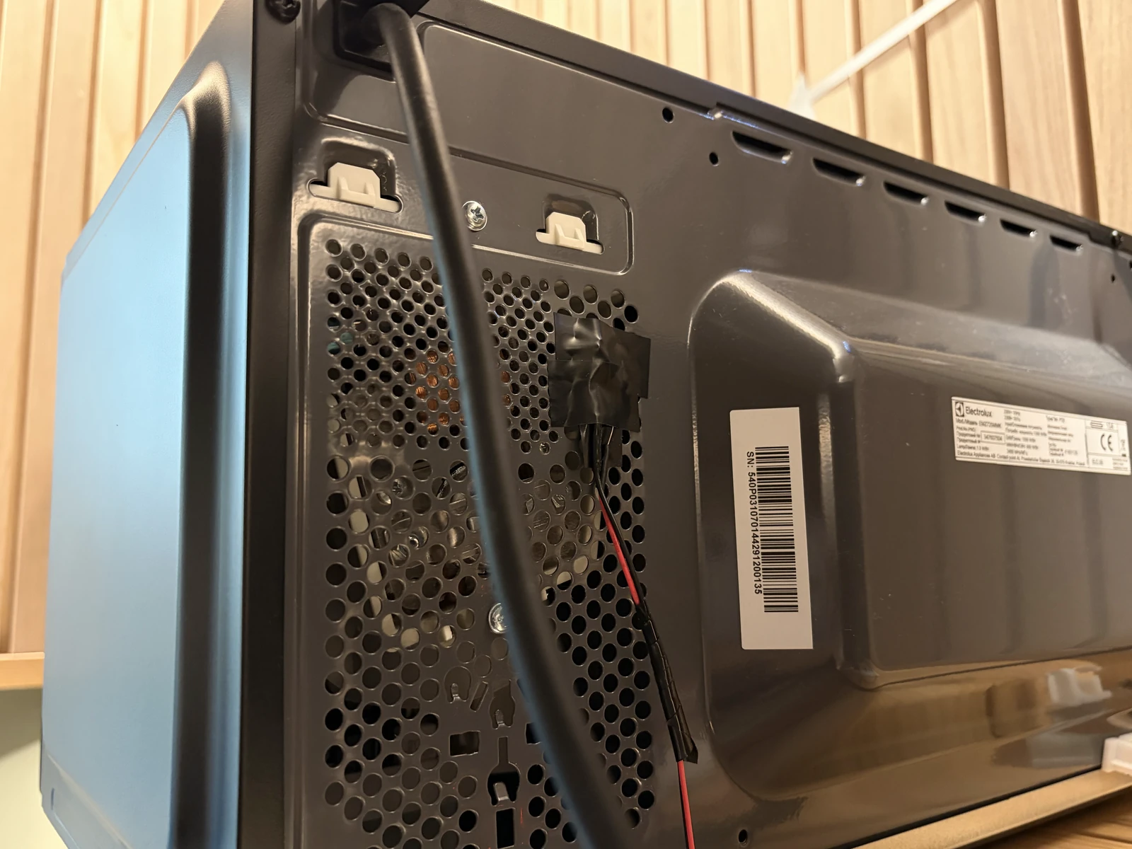The back of the microwave, with the photosensor taped over its vent